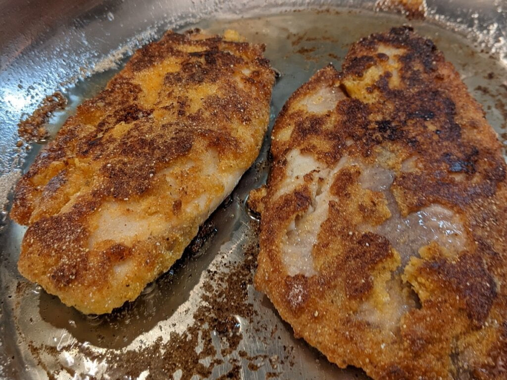 fried fish cornmeal in pan on second side