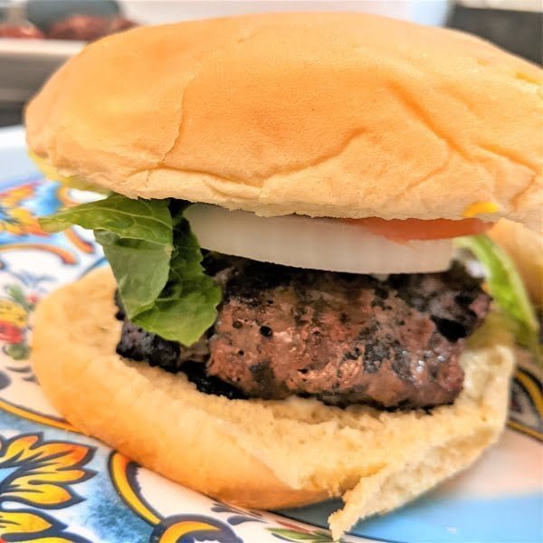 Grilled juicy burger that was cooked with hot dogs