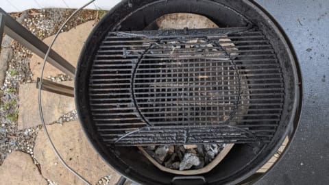 Hinged sides of grill grate lifted open for refilling charcoal hinged sides of grill grate lifted open for refilling charcoal