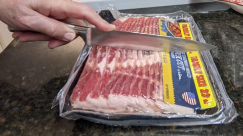 how to cook bacon in frying pan starts with cutting bacon in half