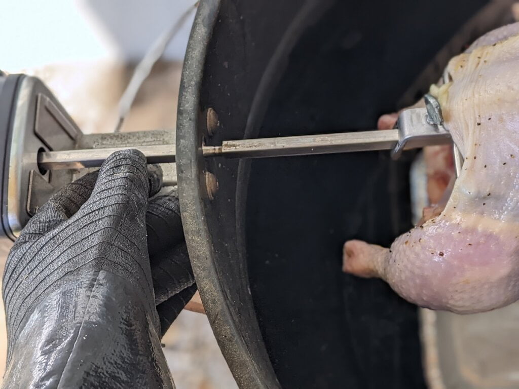 insert loaded rotisserie rod through ring into motor port