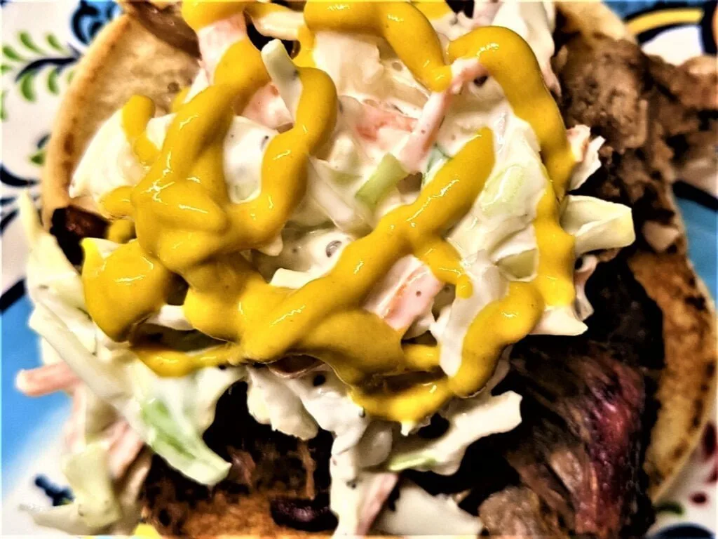 Layering pulled pork sandwich with mustard layering pulled pork sandwich with mustard