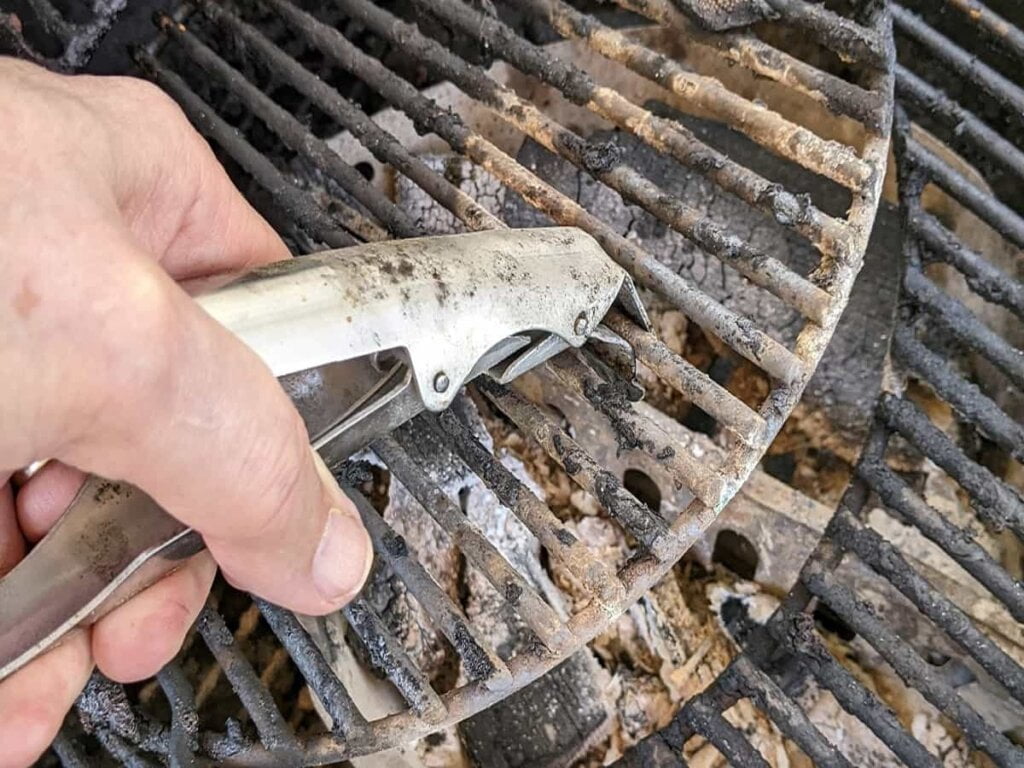 lifting center piece of grill to add charcoal