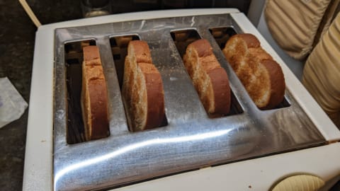 lightly toasted bread in toaster is first step of how to make cinnamon toast in the oven lightly toasted bread in toaster is first step of how to make cinnamon toast in the oven