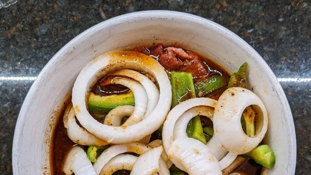 meat and veggies in marinade for steak fajitas grill recipe