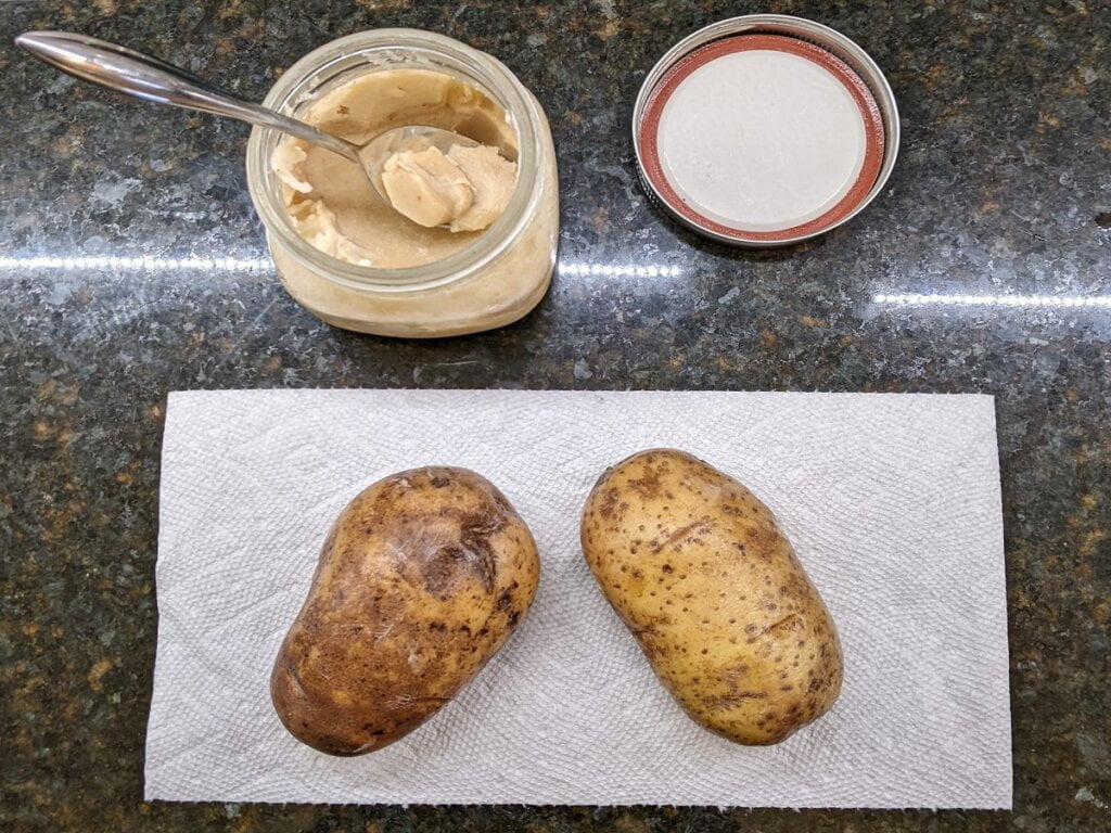 Oiling the potatoes for oven baked potatoes