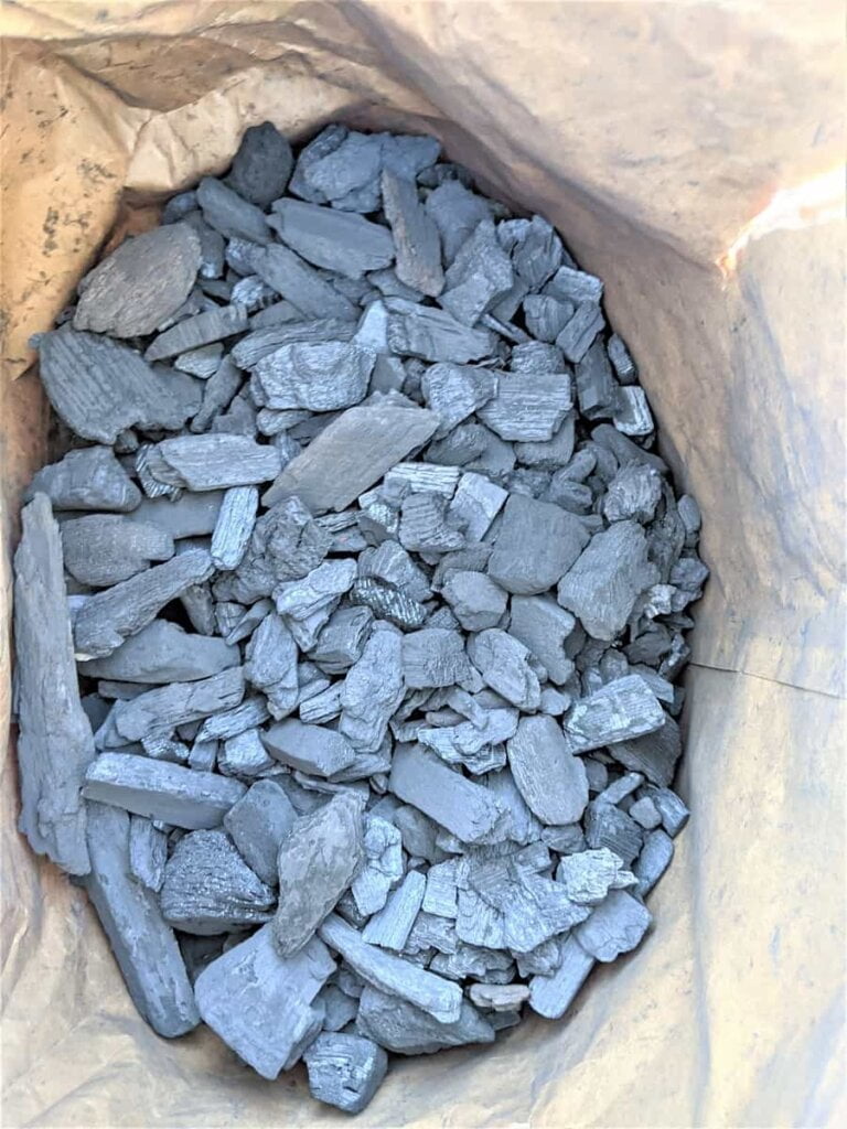 open bag of lump charcoal for grilling on charcoal