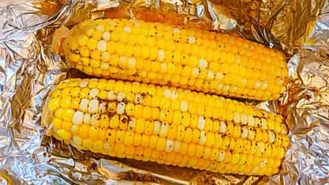 opening up corn on the cob in the oven in foil after baking