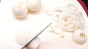peeled onions sliced and separated into rings for open steak sandwich recipe