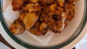 placing fried mushrooms on paper towel for serving