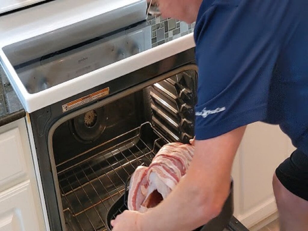 placing prepped turkey into oven