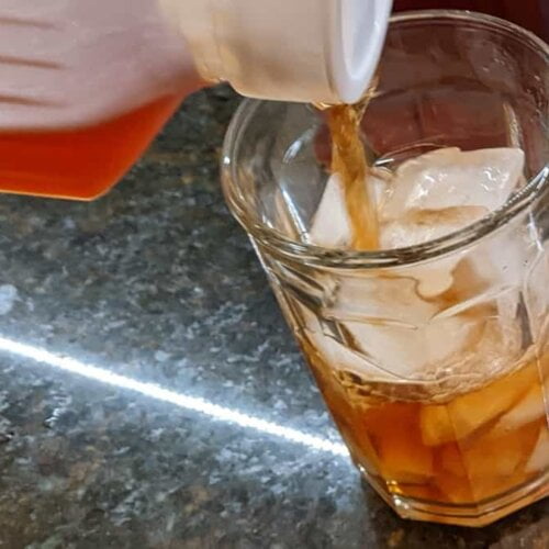 pouring southern sweet tea into glass for southern sweet tea recipe