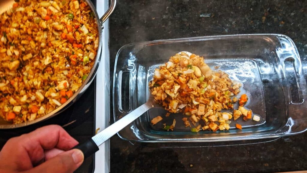 prep step to fill baking dish with asian chicken rice casserole mixture