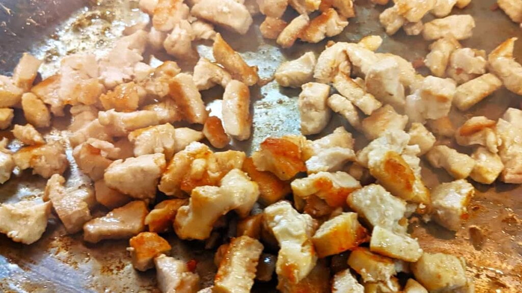 prep step to stir fry chicken cubes for asian chicken rice casserole