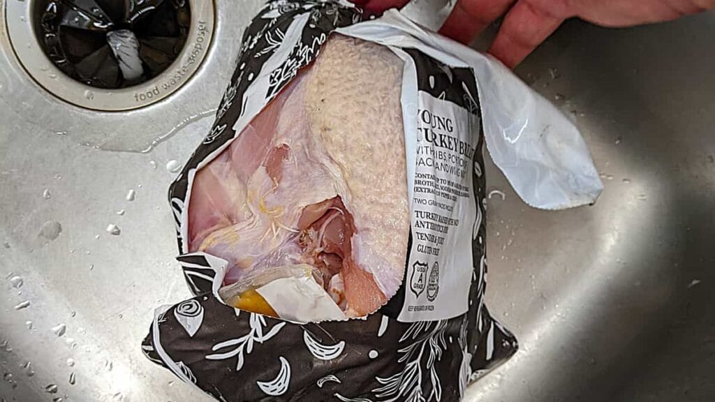 prepare turkey breast on the grill by removing innards and rinsing