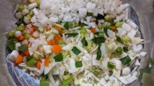 prepared vegetables in large mixing bowl for asian chicken rice casserole