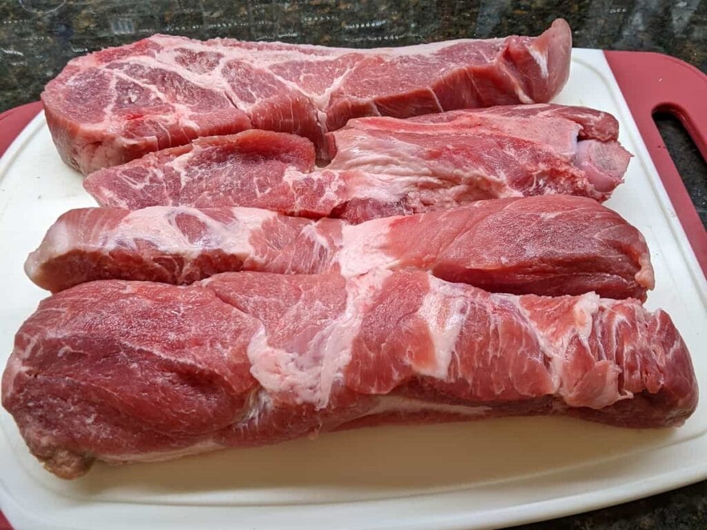 preparing carved individual ribs on cutting board for ribs on the charcoal grill