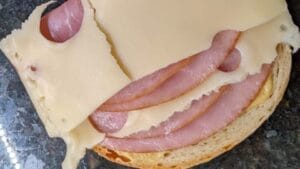 preparing layers for grilled ham and cheese sandwich recipe