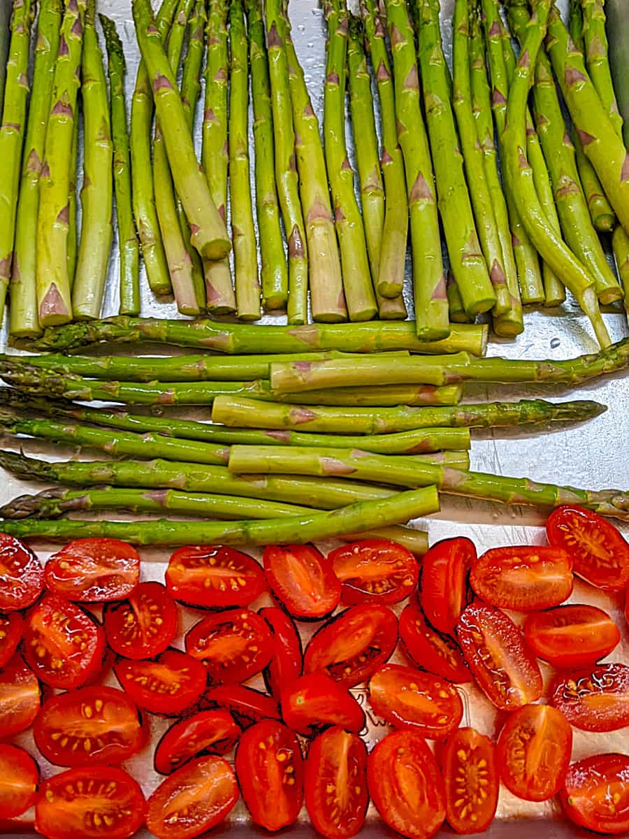 Prepped Veggies on Baking Pan for How to Make Roasted Asparagus and Cherry Tomatoes