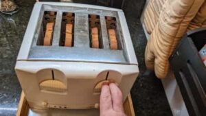 prepping bread in toaster for cinnamon toast recipe