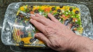 pressing together the layers in 7 layer dip recipe