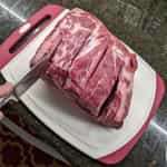 pulled-pork-on-a-charcoal-grill-preparation-with-deep-cuts-1