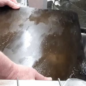 put cooled down pizza steel in sink to start cleaning
