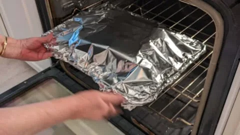 putting foil tent covered burger sliders in oven for steaming putting foil tent covered burger sliders in oven for steaming