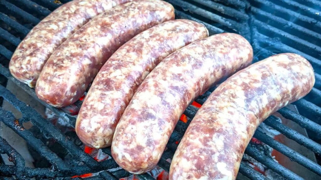 raw brats on the grill