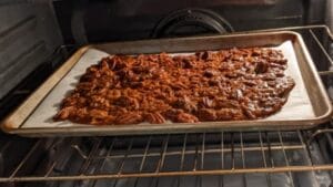 removing baked honey roasted pecans to cool on baking sheet for an hour