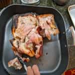 removing-large-fat-areas-before-shredding-pulled-pork-roast-from-the-charcoal-grill-1