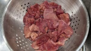 rinsing chicken livers in colander for pate recipe