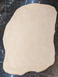 01-Roll-out-the-pizza-dough-view-medium Roll out the pizza dough for recipe for supreme pizza