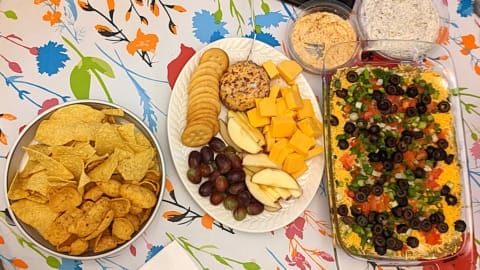 serving 7 layer dip with other appetizers and snacks