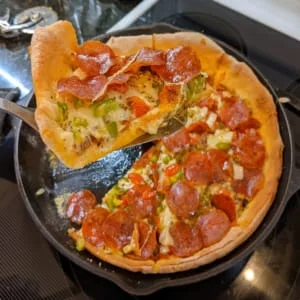 serving pizza slice from homemade oven baked pizza