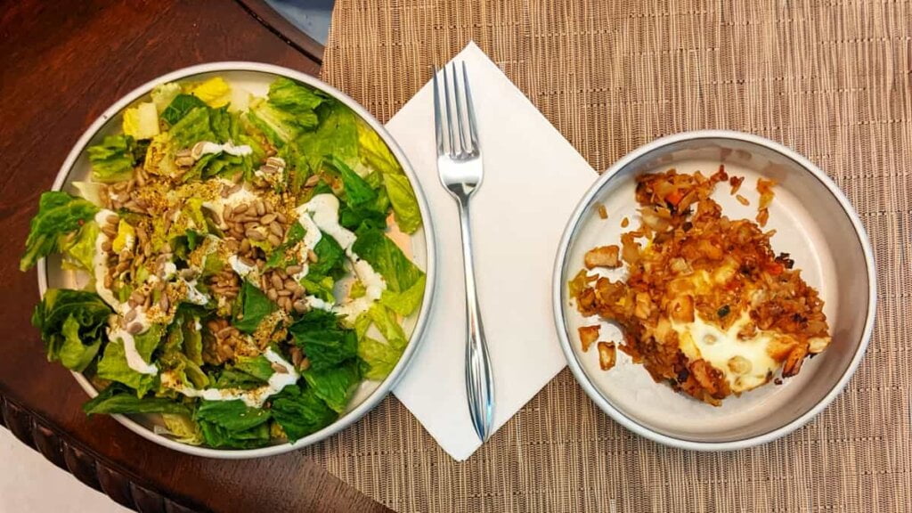 serving simple lettuce salad with asian chicken and rice casserole meal