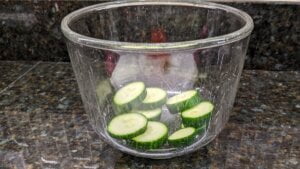 sliced cucumber in salad bowl for cucumber tomato salad