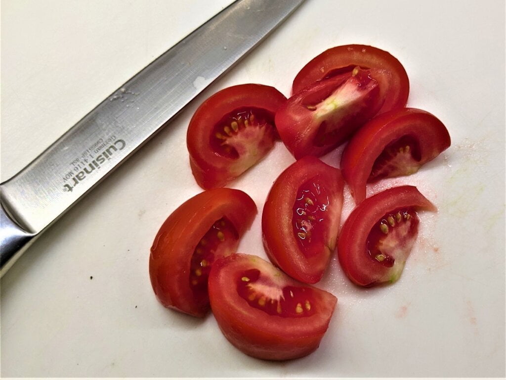 sliced tomato sections on cutting board