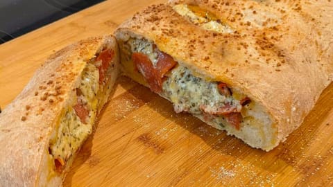 slicing servings of calzone with pizza dough slicing servings of calzone with pizza dough