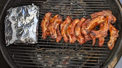 slow cooking ribs on indirect heat on charcoal grill