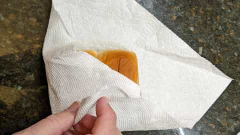 sprinkle water across rolls and paper towel and fold up
