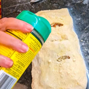 sprinkling parmesan cheese on top of calzone before baking sprinkling parmesan cheese on top of calzone before baking
