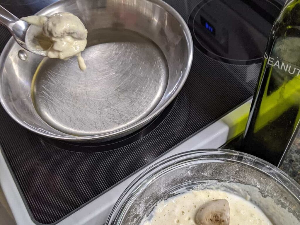 starting to cook fried mushrooms in frying pan