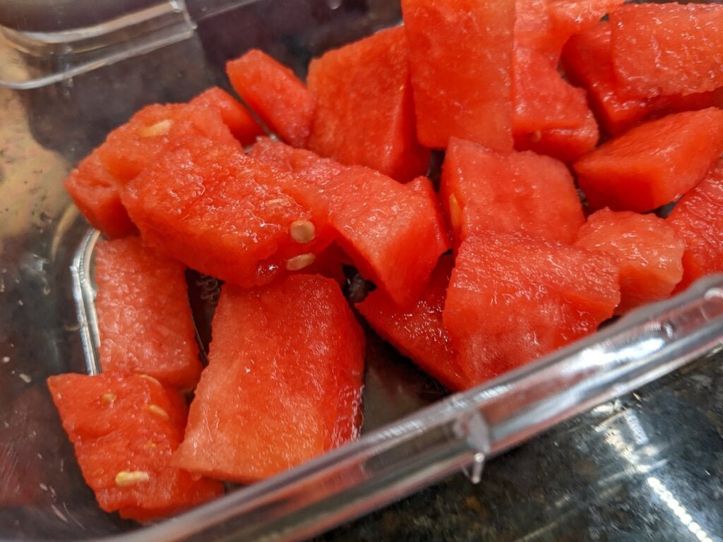 Storing watermelon chunks in food storage container storing watermelon chunks in food storage container
