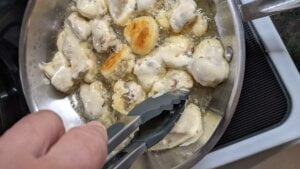 turn fried mushrooms over as they brown