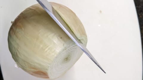 use the knife to lift up the slit skin of the onion use the knife to lift up the slit skin of the onion