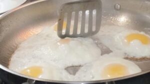 using spatula to separate joined sunny side up eggs recipe