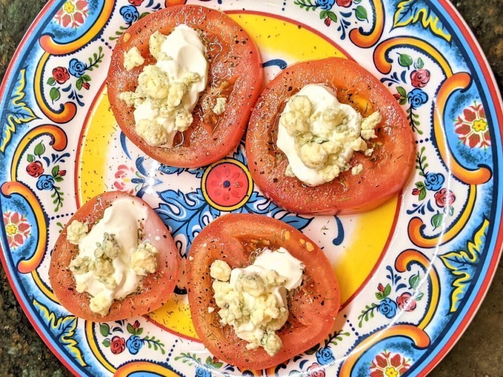 variations of sliced tomatoes with cheese on top